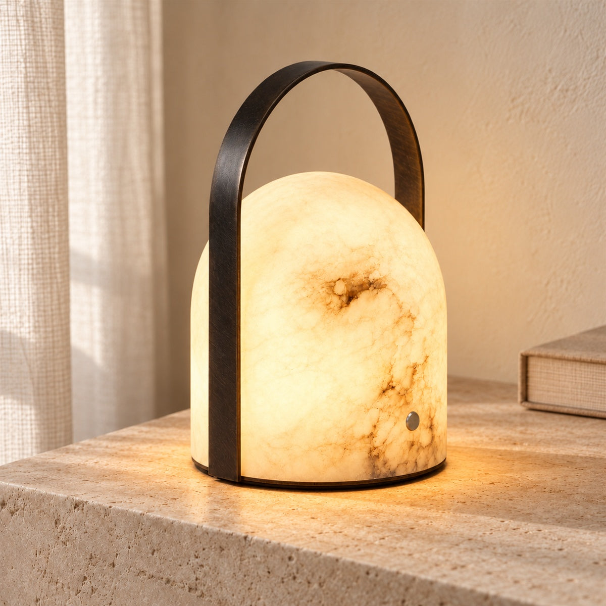 Aurelle lamp switched on, glowing warmly through the natural stone and revealing its veining